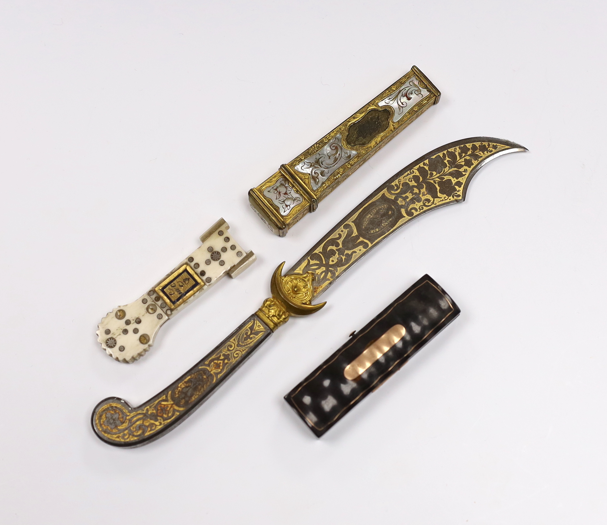 Two 19th century needle cases, one in bone, and one in gilt metal with mother-of-pearl inlay, a tortoiseshell toothpick case and a Toledo paperknife, paper knife 20cm
